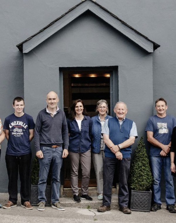 The Cushen family members standing in front of the mill