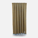 A Ochre Clash Mohair Throw Blanket is spreaded and hung on a rope